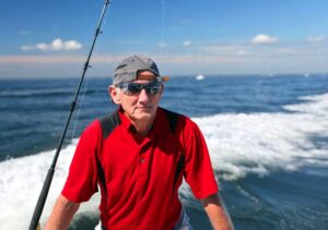 Happy man on boat in sea with sunglasses