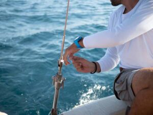 Man on boat working with fishing line