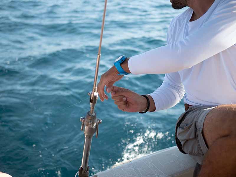 Man on boat working with fishing line