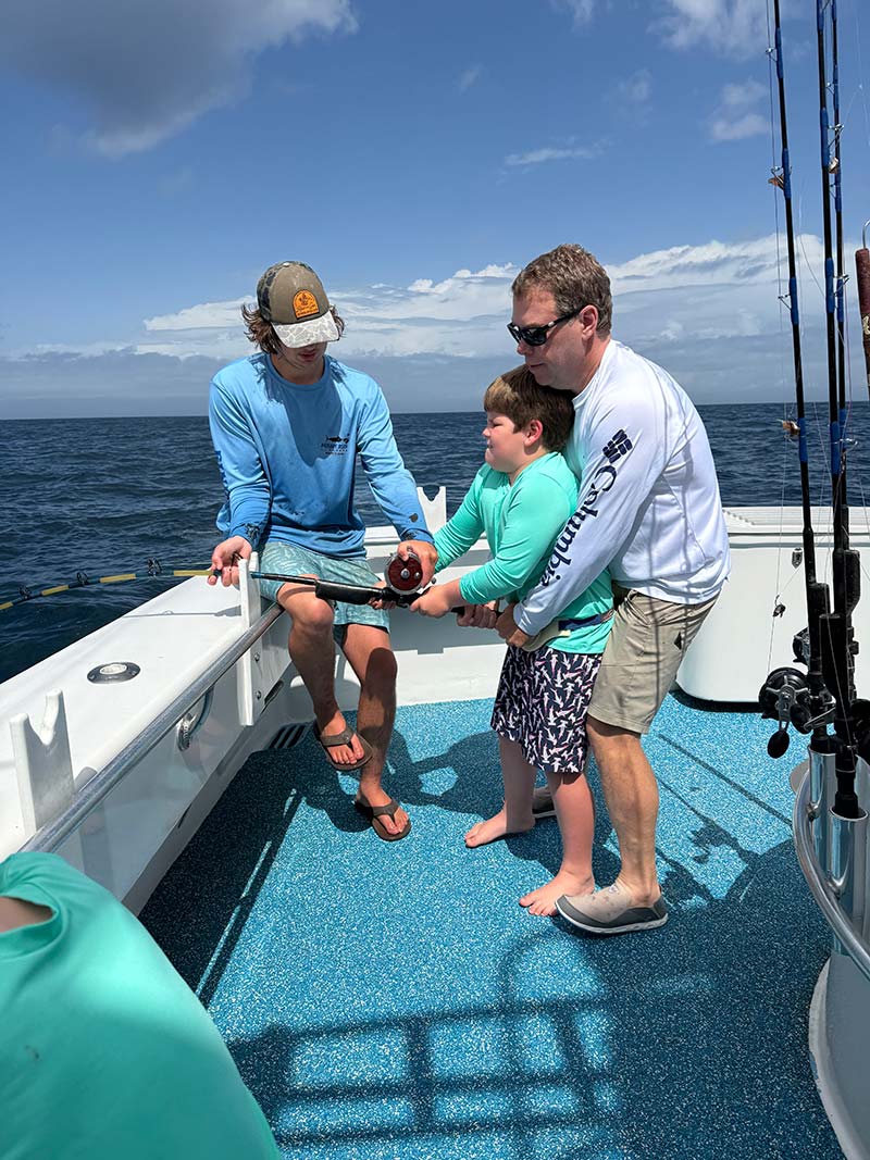 child fishing with dad